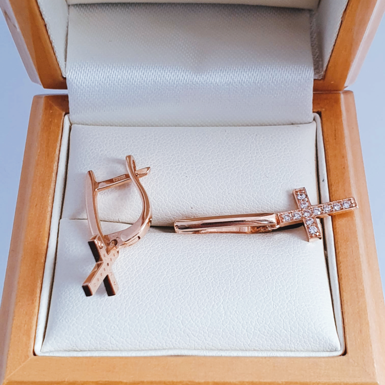Golden earrings with litlle crosses covered white zirconia stones