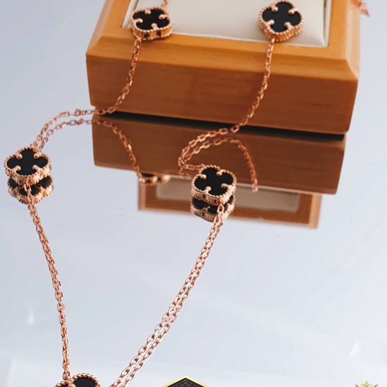 Clover leaf golden neclase covered black enamel