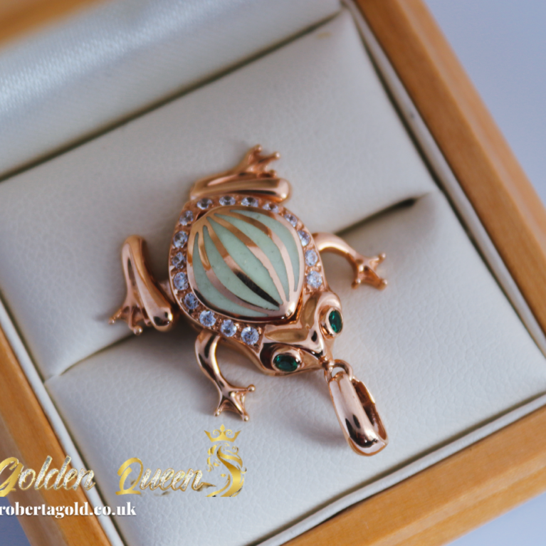 Golden frog with green enamel and zirconia